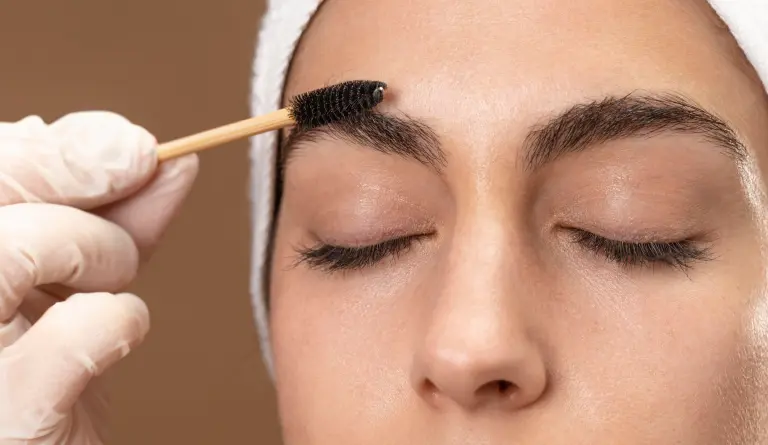 woman-doing-eyebrow-treatment-her-client (1)